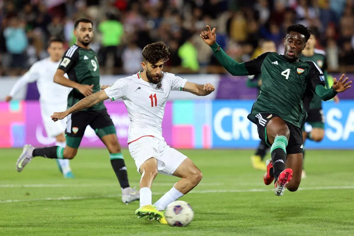 Soccer Football - World Cup - AFC Qualifiers - Third Round - Group A - Iran v United Arab Emirates - Azadi Sports Complex, Tehran, Iran - March 20, 2025 Iran's Ali Gholizadeh in action with United Arab Emirates' Kouame Kouadio  Majid Asgaripour/WANA (West Asia News Agency) via REUTERS