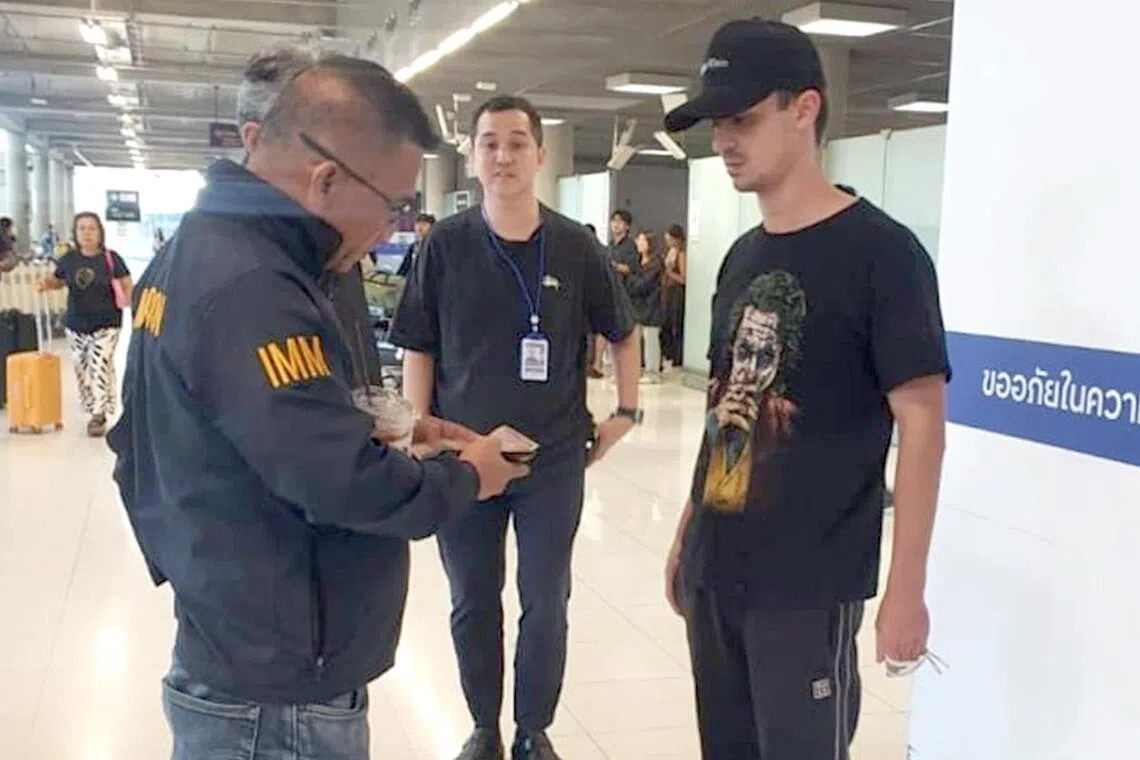 A Russian, identified only as Georgii, is seen here being questioned at Subarnabhumi airport in Bangkok in connection with a sex stunt on Phuket island.
