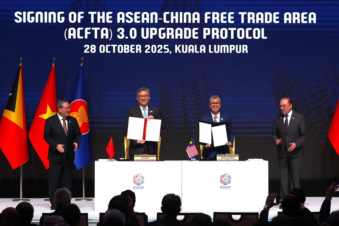 Malaysia's Investment, Trade and Industry Minister Tengku Zafrul Aziz (right) and Chinese Commerce Minister Wang Wentao signed the pact in Kuala Lumpur on Oct 28.