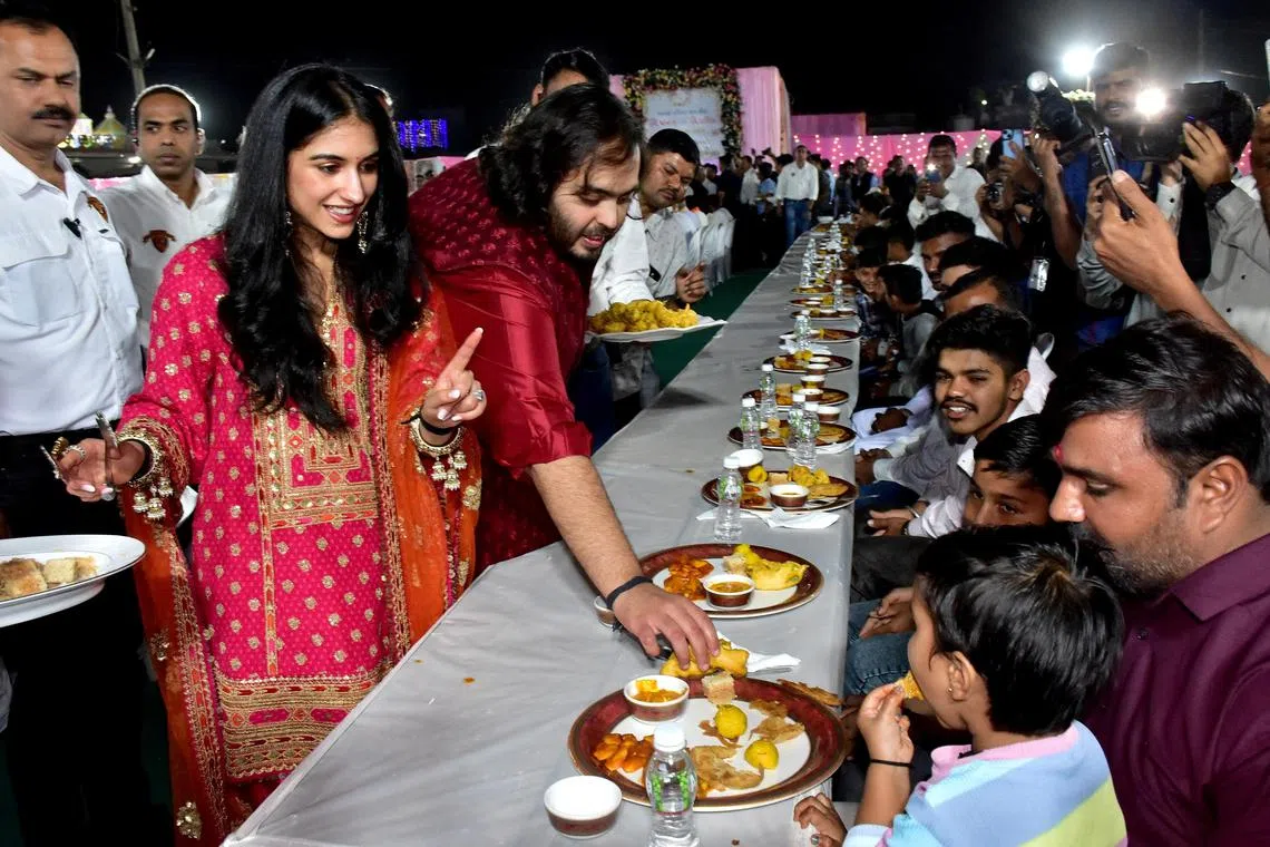Mr Anant Ambani, son of Mukesh Ambani, and Ms Radhika Merchant,  serve traditional Gujarati food to villagers ahead of their pre-wedding celebrations.