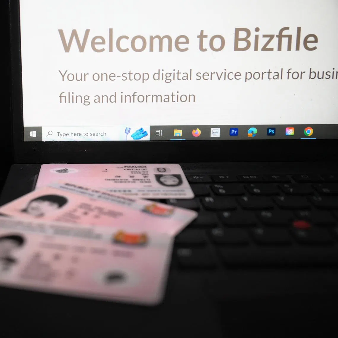 Generic picture of an NRIC with the webpage of the Bizfule, the business filing portal of Accounting and Corporate Regulatory Authority (ACRA).