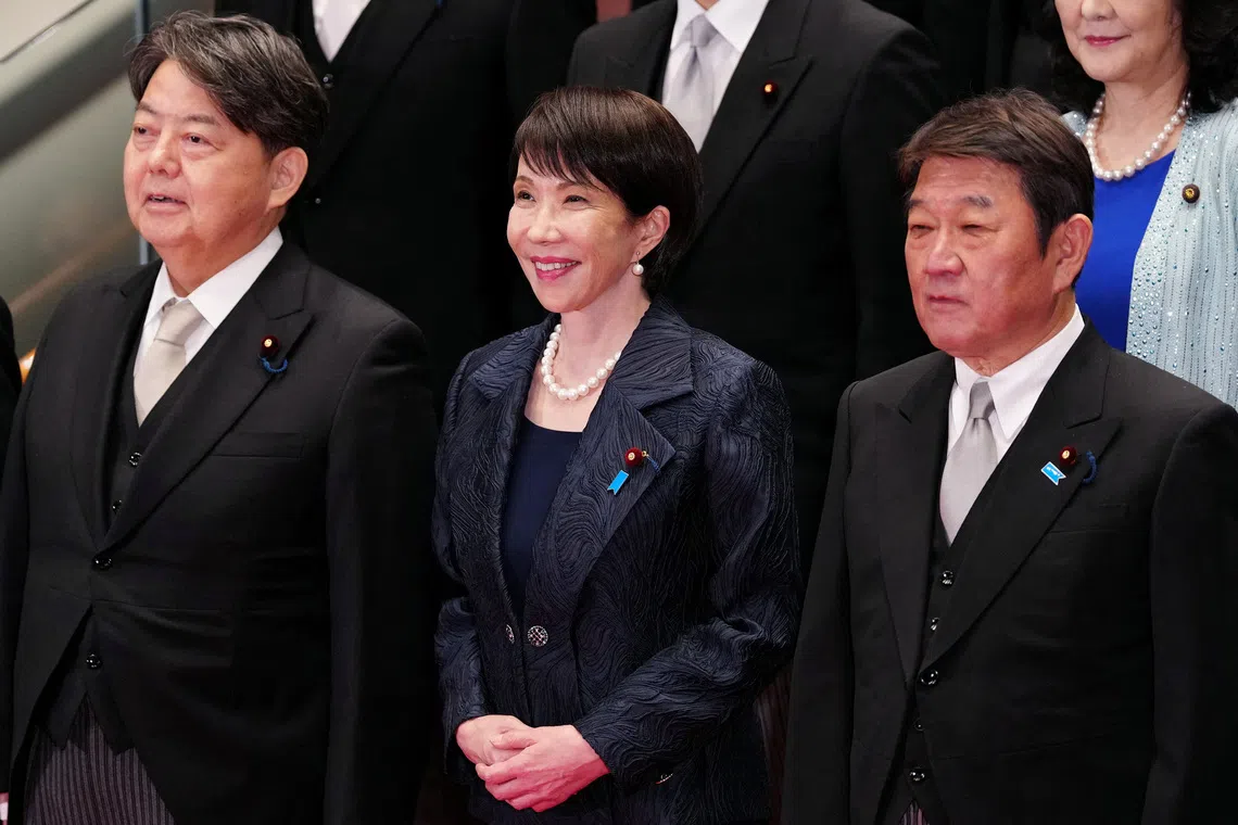 Japanese Prime Minister Sanae Takaichi (front C) and her new cabinet members pose for a group photo in Tokyo, Japan, Oct. 21, 2025.    Jia Haocheng/Pool via REUTERS