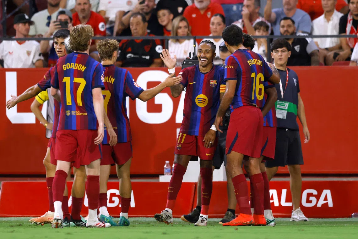 Barcelona captain Raphinha celebrates scoring his third goal with teammates during their 3-1 victory over Sevilla on Sept 19.