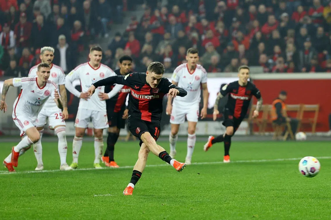 Soccer Football - DFB Cup - Semi Final - Bayer Leverkusen v Fortuna Duesseldorf - BayArena, Leverkusen, Germany - April 3, 2024 Bayer Leverkusen's Florian Wirtz scores their fourth goal from the penalty spot REUTERS/Wolfgang Rattay