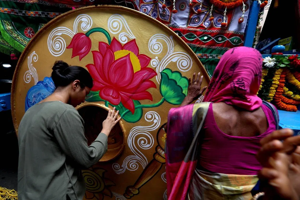 Indian devotees greet a holy chariot during the annual Jagannath Rath Yatra festival in Kolkata, India, on July 16.