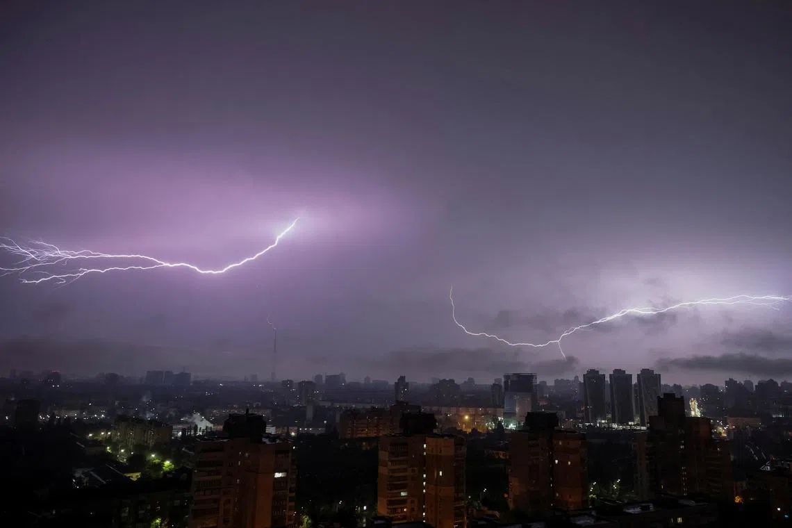 A flash of lightning illuminating the sky over the city during an air raid alert, amid Russia's attack on Ukraine, in Kyiv, Ukraine, on June 12, 2024. 