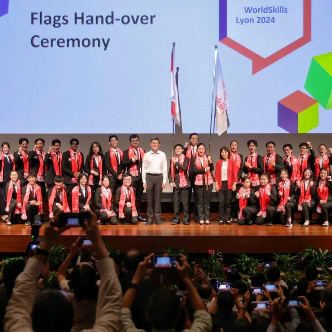 Education Minister Chan Chun Sing (white shirt) and CEO of ITE and official delegate for WorldSkills Singapore Low Khah Gek (red jacket) taking a group photo with members of Team Singapore bound for the upcoming 47th WorldSkills Competition (WSC) in Lyon, France, after officiating the symbolic handing over of Singapore and WorldSkills Singapore Flags during a send-off ceremony at Nanyang Polytechnic on Aug 29, 2024. The contingent  - comprising 35 youths from the Institute of Technical Education (ITE), the polytechnics and SBS Transit - will compete in 30 skill areas, at the upcoming 47th WorldSkills Competition (WSC) in Lyon, France, from 10 to 15 September 2024. ST PHOTO: KEVIN LIM etsend29
