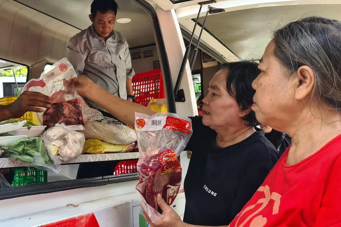Patrons checking beef sold at a government-run food bazaar in Jakarta ahead of Ramadan.