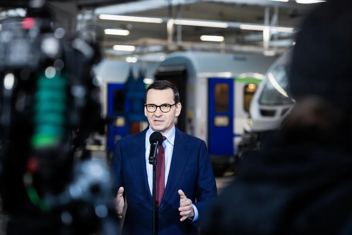 epa10424648 Poland's Prime Minister Mateusz Morawiecki speaks to the media during a visit to the headquarters of the H. Cegielski Railway Vehicles Factory in Poznan, Poland, 23 January 2023. During the visit Morawiecki announced that Poland will 'formally ask Germany for permission to hand over some of its German-made Leopard 2 tanks to Ukraine', PAP reported.  EPA-EFE/MAREK ZAKRZEWSKI POLAND OUT