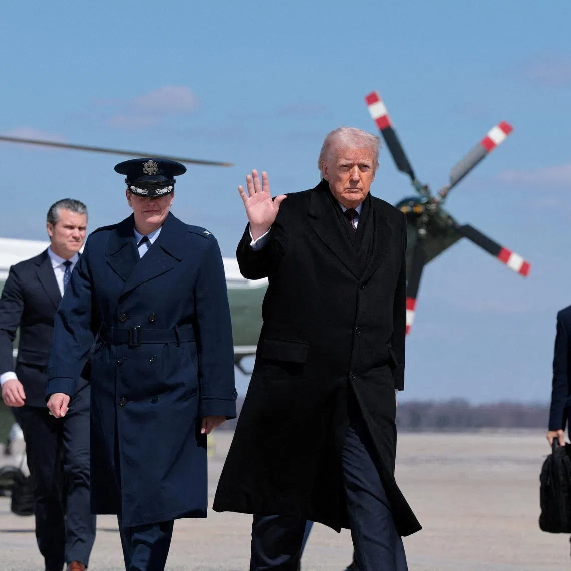 FILE PHOTO: U.S. President Donald Trump gestures as he boards Air Force One to travel to Dover Air Force Base, as he departs from Joint Base Andrews, Maryland, U.S., March 18, 2026. REUTERS/Kylie Cooper/File Photo