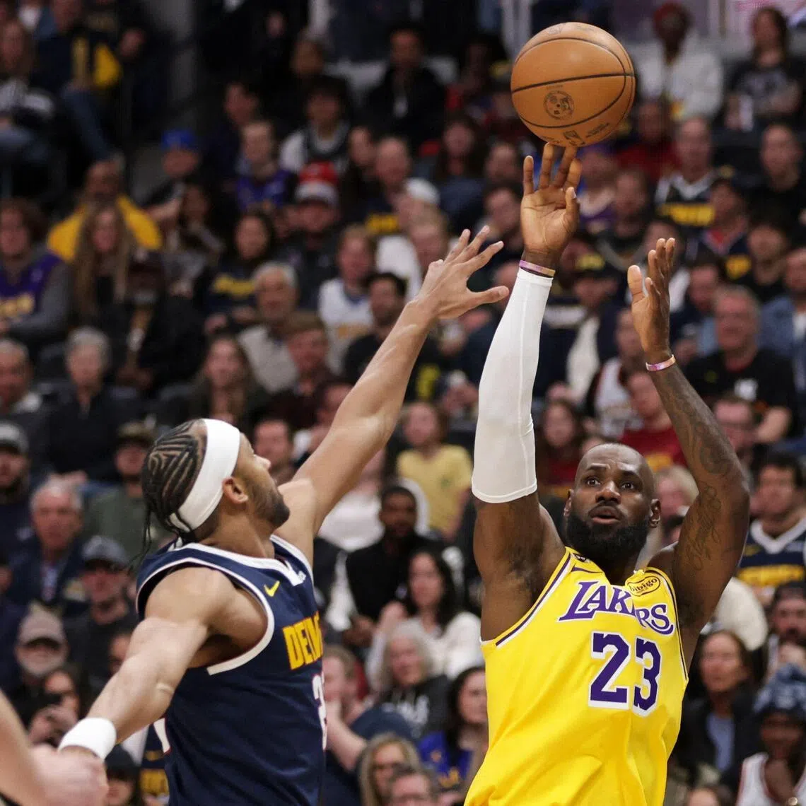 LeBron James of the Los Angeles Lakers takes a shot against Zeke Nnaji of the Denver Nuggets during the first quarter at Ball Arena.