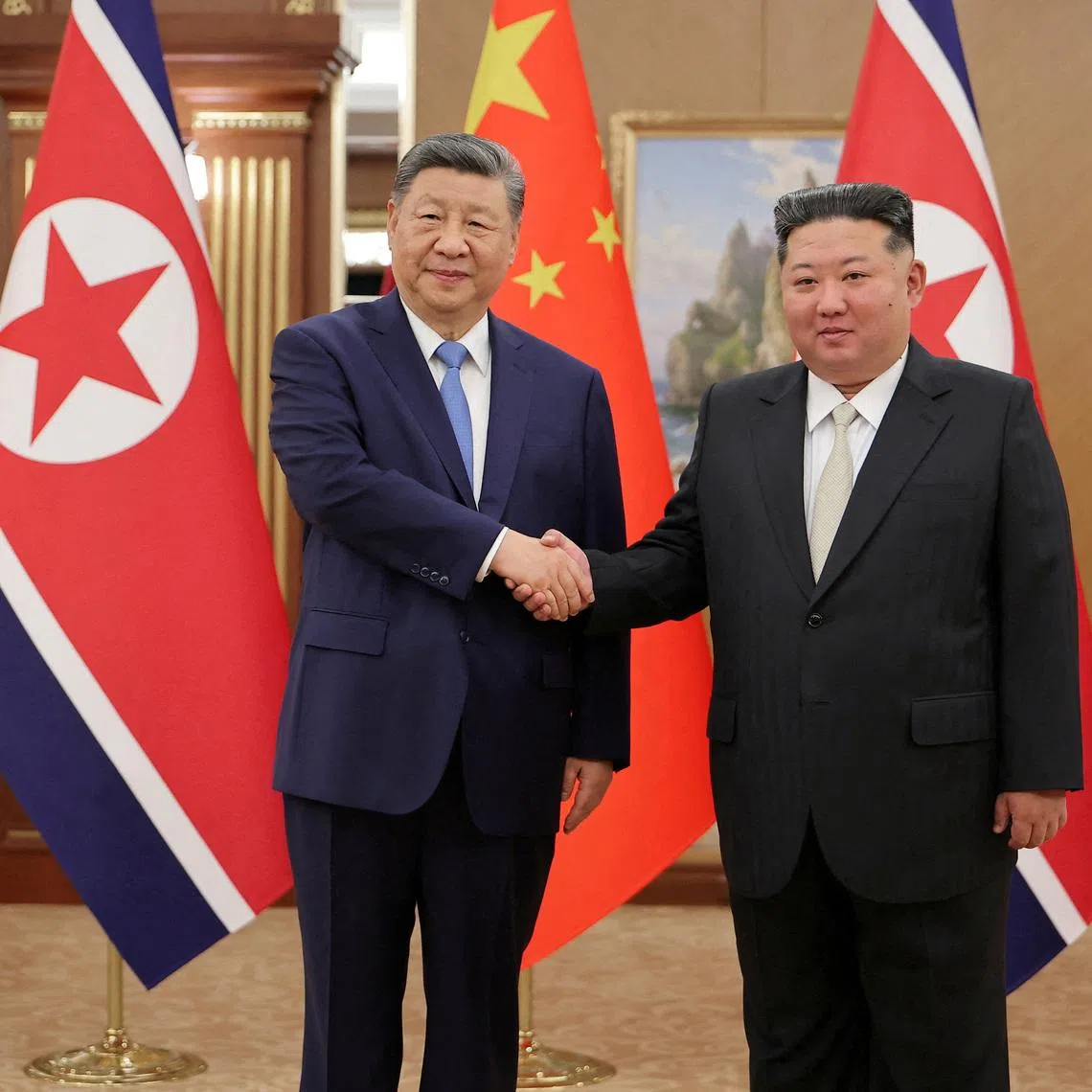 Chinese President Xi Jinping shaking hands with North Korean leader Kim Jong Un during the former's state visit to Pyongyang, North Korea, on June 8.