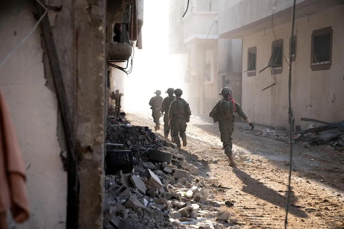Israeli soldiers operate in the Gaza Strip amid the ongoing conflict between Israel and the Palestinian Islamist group Hamas, in this handout picture released on December 28, 2023.   Israel Defense Forces/Handout via REUTERS/File Photo