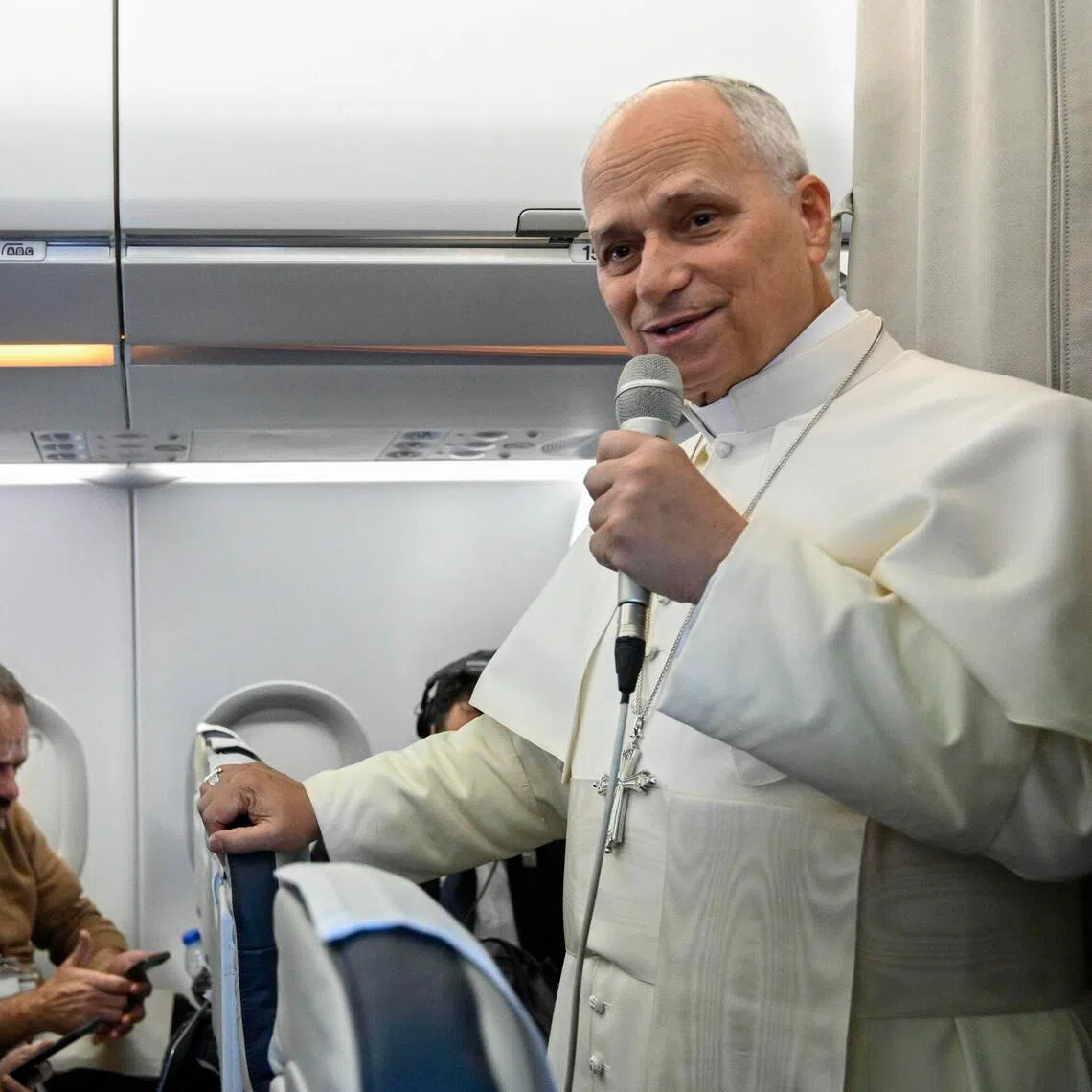 Pope Leo XIV (right) speaking to journalists aboard a flight to Rome at the end of his apostolic journey to Lebanon, on Dec 2. 
