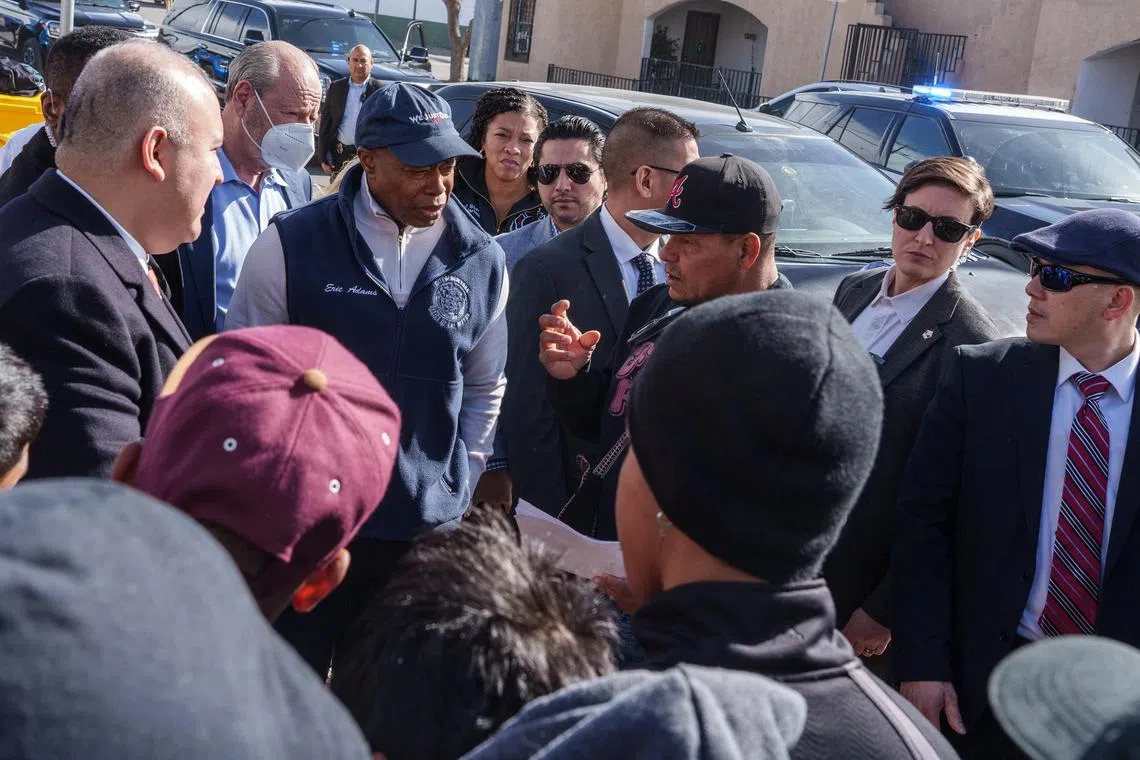 New York City Mayor Eric Adams speaks with a group of migrants while visiting a shelter run by Sacred Heart Church in El Paso, Texas, on Jan 15, 2023.