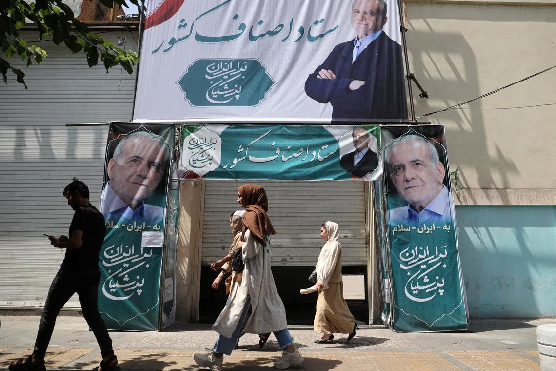 A banner featuring presidential candidate Masoud Pezeshkian is displayed on a street in Tehran, Iran July 4, 2024. Majid Asgaripour/WANA (West Asia News Agency) via REUTERS