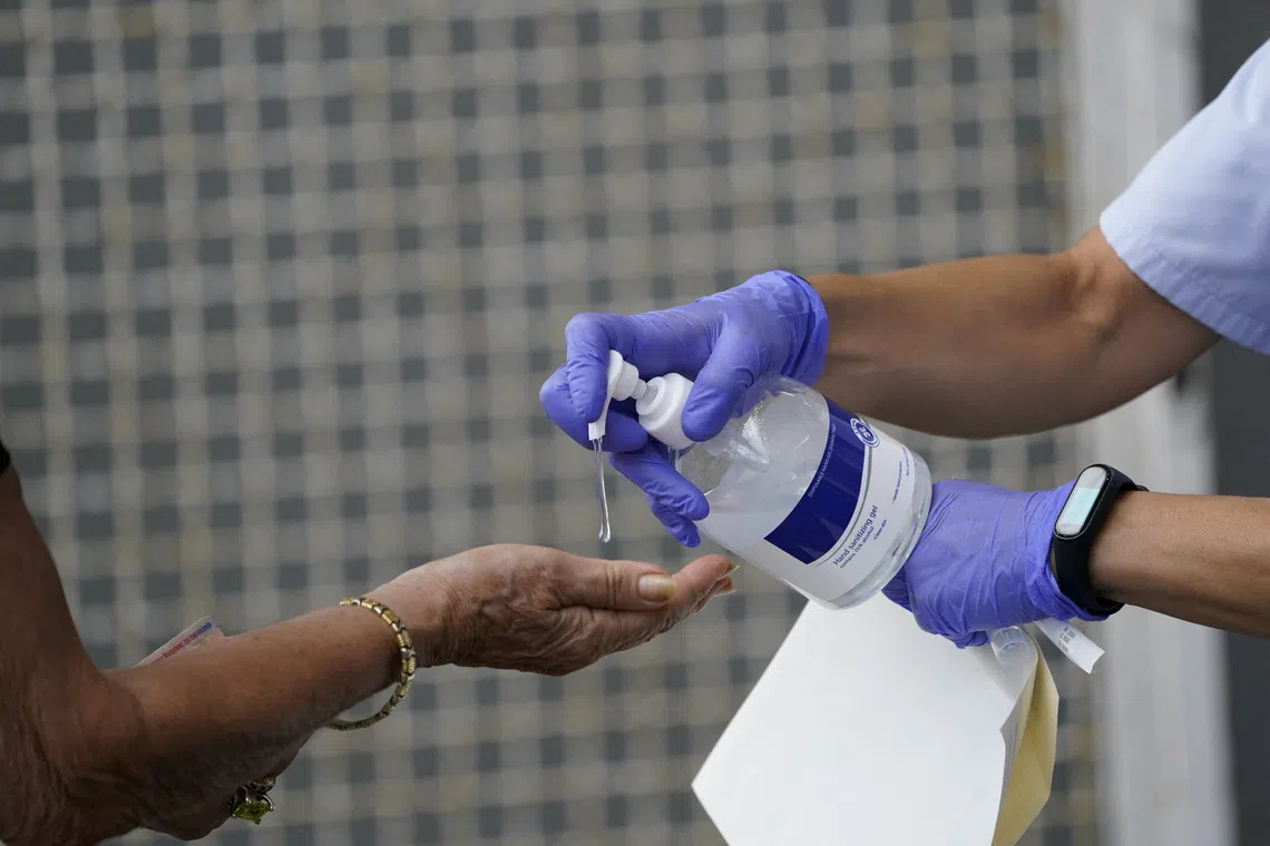 A medical team administers hand sanitiser to a resident of the Basque town of Azpeitia, Spain, August 17, 2020. REUTERS/Vincent West/File Photo