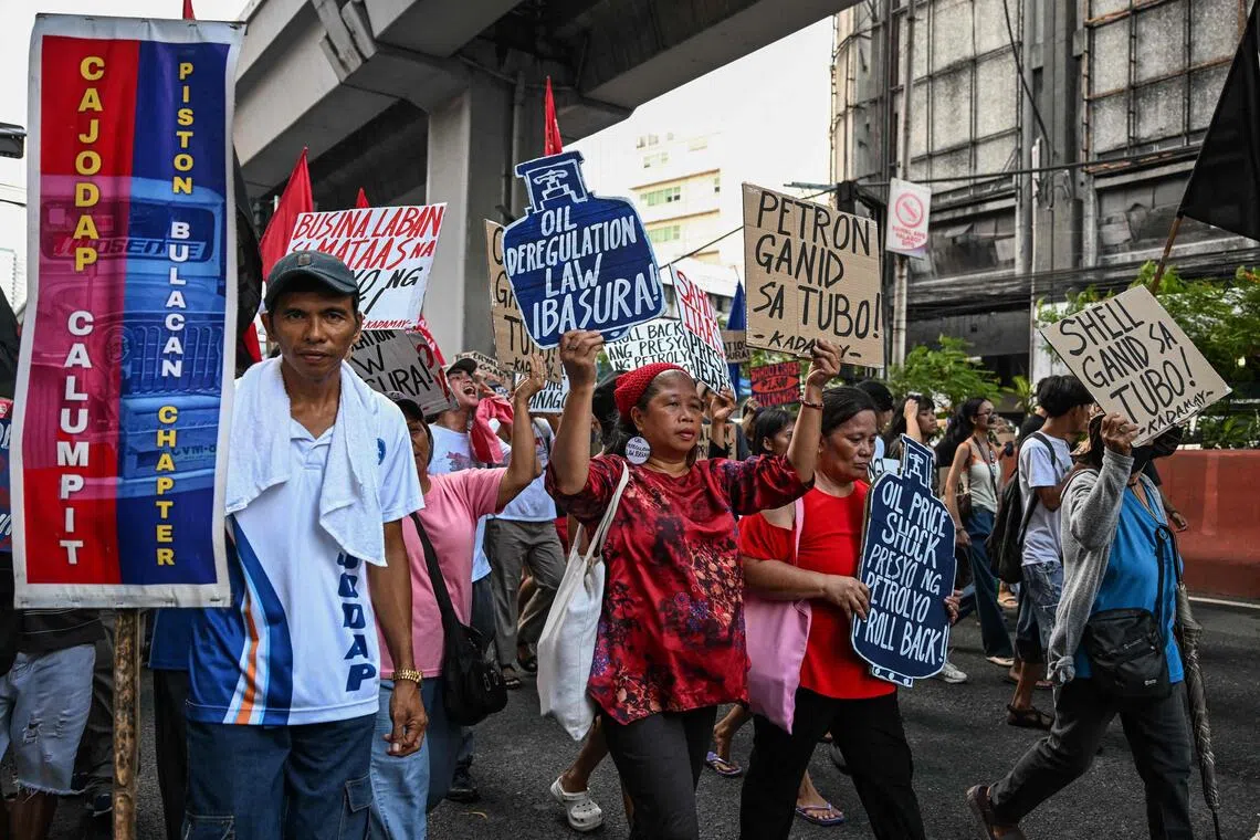 Jeepney drivers and consumer advocates hold a rally to protest soaring oil prices that have sunk the peso.