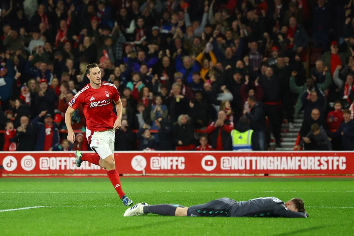 Nottingham Forest's Chris Wood celebrates scoring their first goal as Crystal Palace's Dean Henderson reacts.