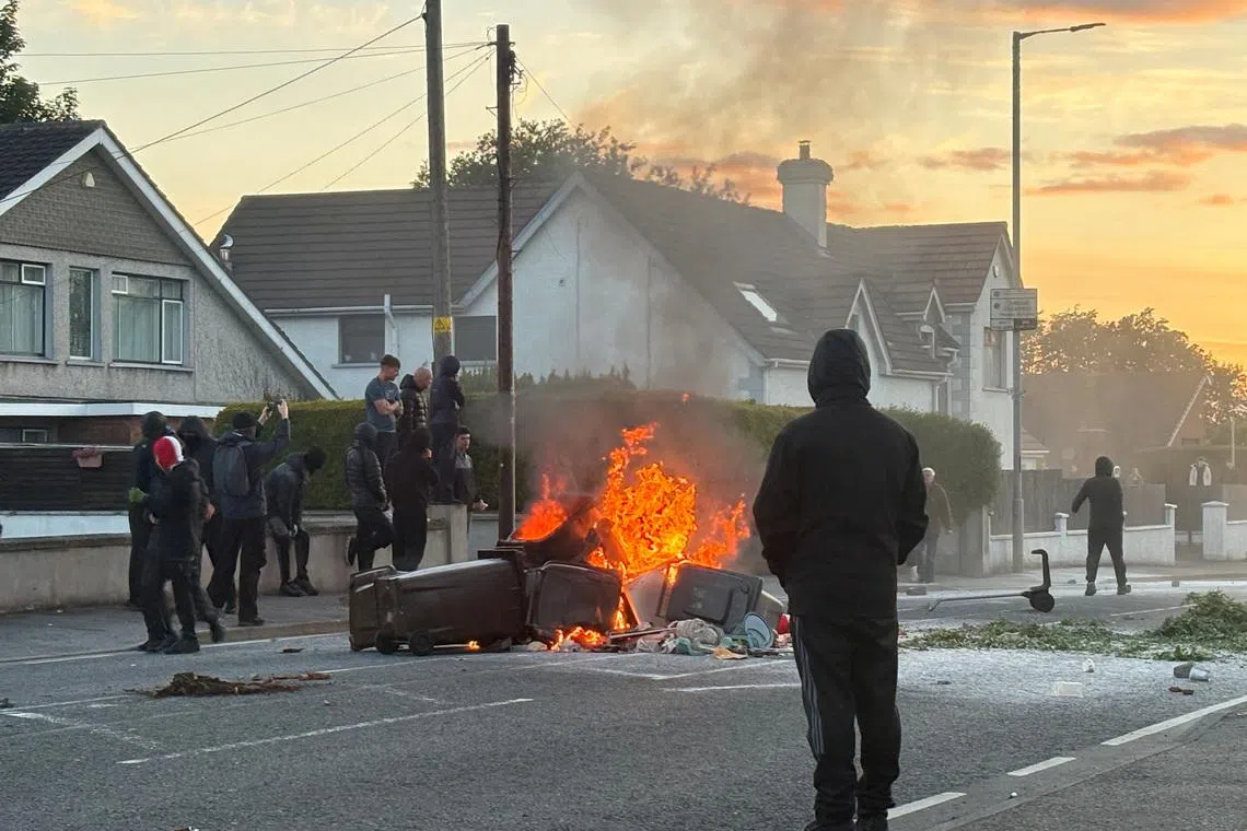 UK minister says violence in Northern Ireland is racist thug