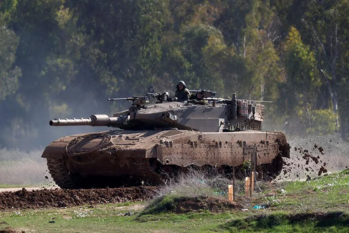 Israeli soldiers manoeuvre a tank near the border with the North Gaza, amid the ongoing conflict between Israel and the Palestinian Islamist group Hamas, Israel January 31, 2024. REUTERS/Amir Cohen