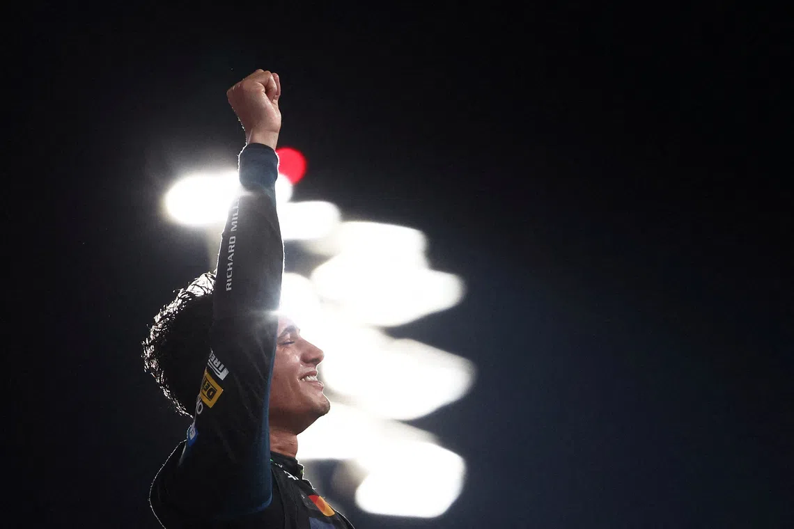McLaren's Lando Norris celebrating on the podium after becoming the 2025 Formula One World Champion in the Abu Dhabi Grand Prix, held at the Yas Marina Circuit, Abu Dhabi, United Arab Emirates, on  Dec 7, 2025.