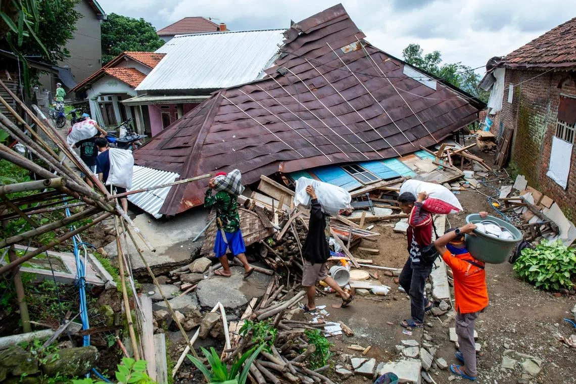 Displaced people salvaging their belongings after land movement struck Padasari village in Tegal, Central Java, Indonesia on Feb 9, 2026, damaging homes, public facilities and schools, leading to the evacuation of thousands of residents. 