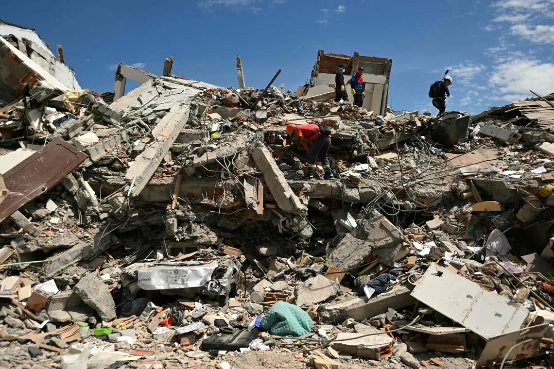 Rescuers searching for survivors amid the rubble of a collapsed building in Pereira on Aug 13, three days after a 7.4-magnitude earthquake hit western Colombia.