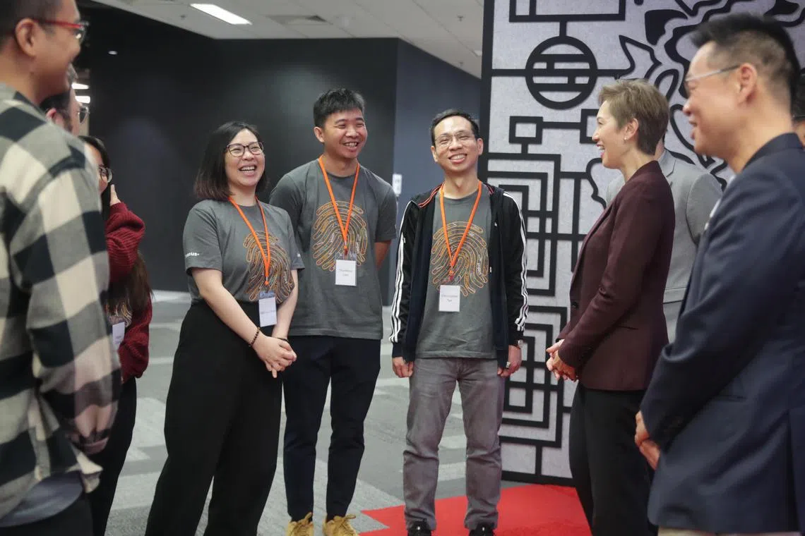 Minister for Communications and Information Josephine Teo chatting with the trainees from Step It Up talent accelerator programme, on Jan 26, 2023.