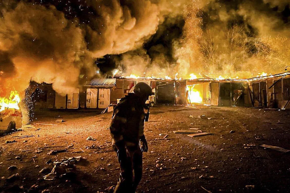Ukrainian rescuers working at the site of a glide bomb attack in Kupyansk, in Ukraine's Kharkiv region, on April 11.