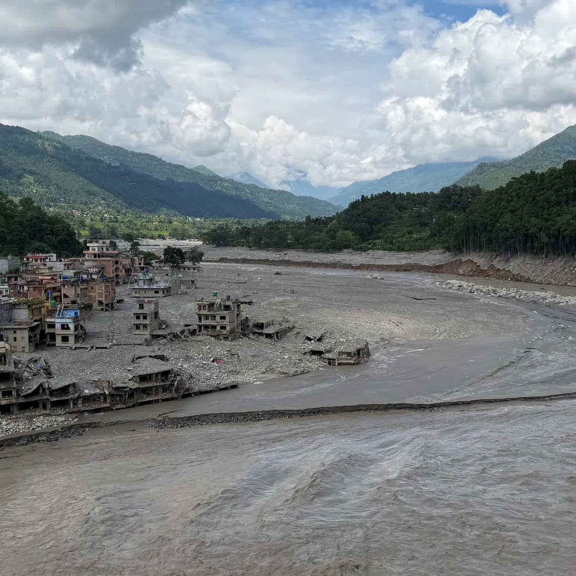 Damaged properties along the Trishuli River where the Tribhuvan Trishuli Secondary School once stood, before it was destroyed by deadly flash floods and mudslides, in Nuwakot, Nepal, August 31, 2026. REUTERS/Sunil Kataria