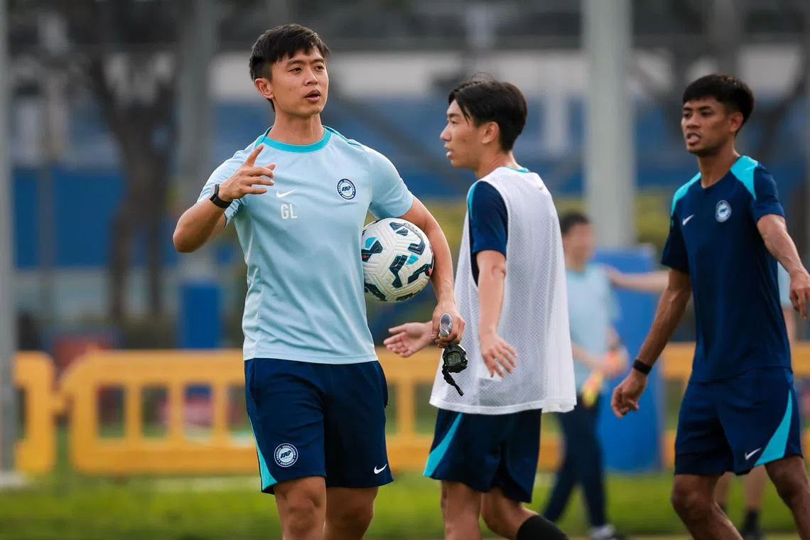 (From left) Interim Lions coach Gavin Lee leads a national team training session at the Kallang Football Hub as Joel Chew and Shah Shahiran look on.