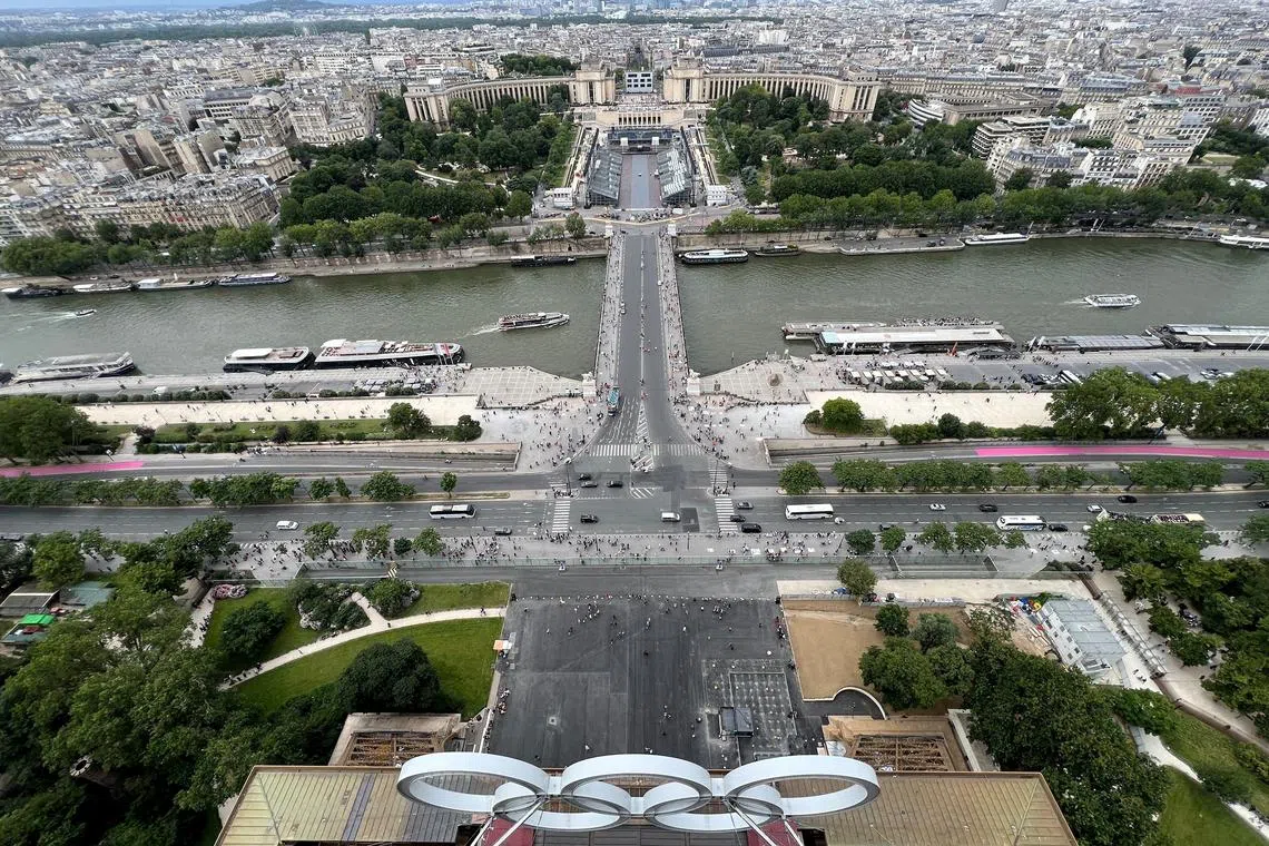 FILE PHOTO: The Olympic rings are displayed on the Eiffel Tower with a general view of Champions Park at the Trocadero, under construction for the Paris 2024 Olympic and Paralympic Games in Paris, France, June 29, 2024.    REUTERS/Fabrizio Bensch/File Photo