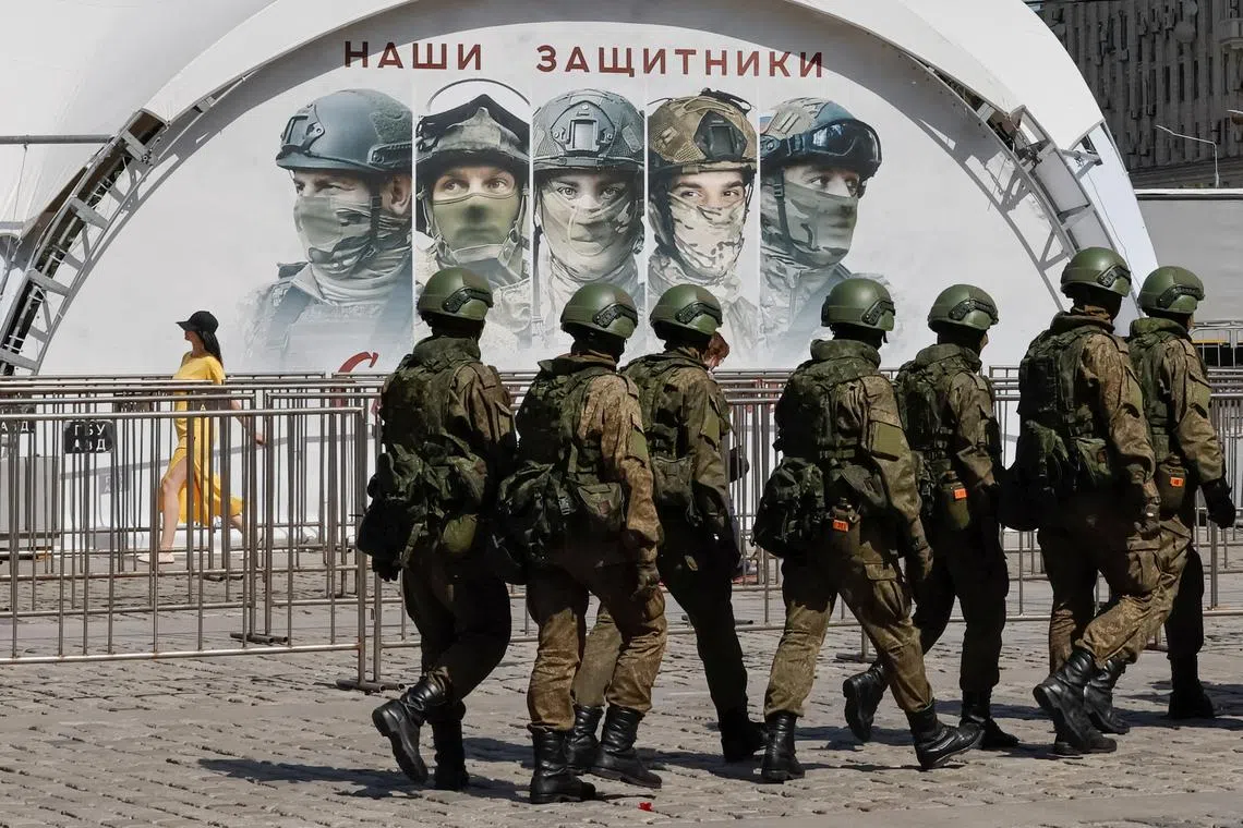 FILE PHOTO: Russian army servicemen walk at an exhibition displaying armoured vehicles and equipment captured by the Russian army from Ukrainian forces in the course of Russia-Ukraine conflict, at Victory Park open-air museum on Poklonnaya Gora in Moscow, Russia May 31, 2024.  REUTERS/Shamil Zhumatov/File Photo