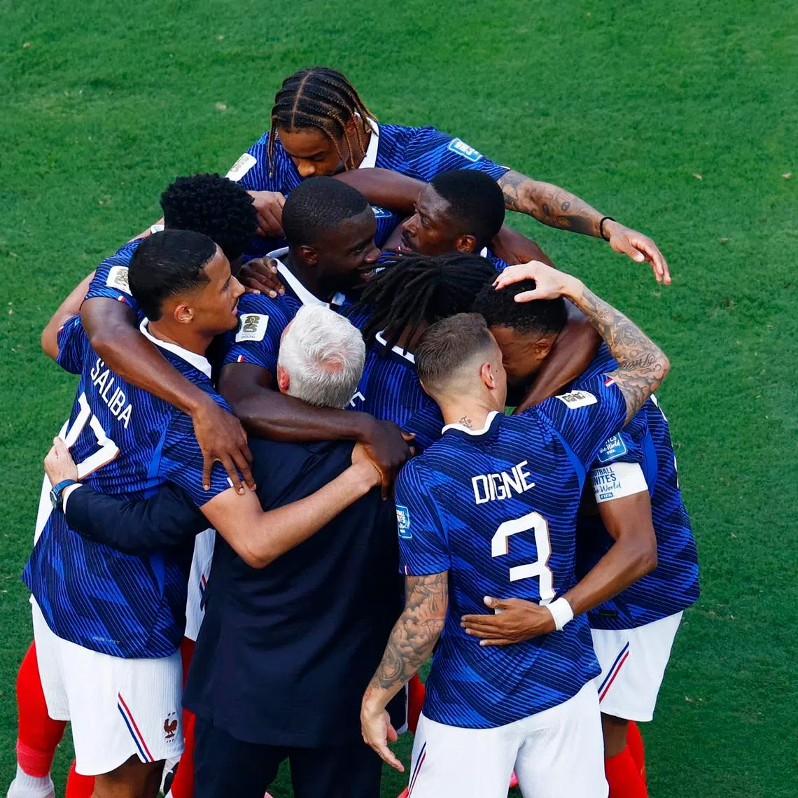 France celebrate their first goal with coach Didier Deschamps.