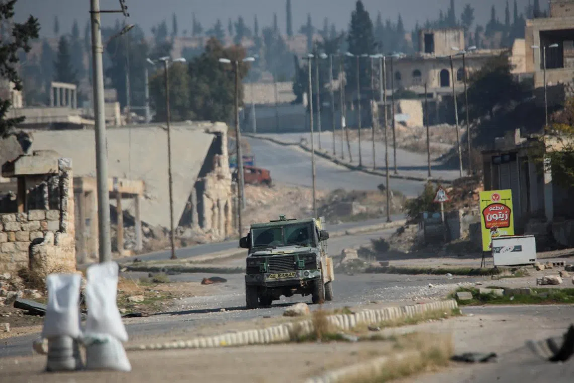FILE PHOTO: Rebels led by the Islamist militant group Hayat Tahrir al-Sham drive along a street in al-Rashideen, Aleppo province, Syria November 29, 2024. REUTERS/Mahmoud Hasano/File Photo