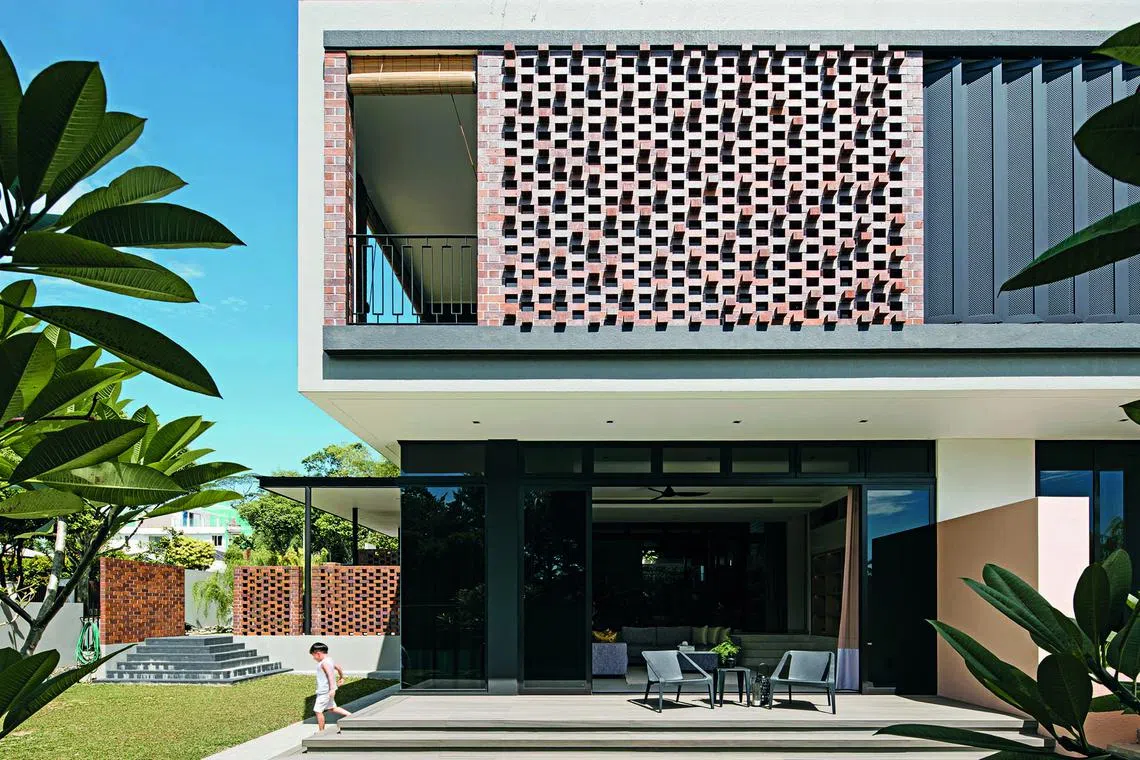 The red brick walls of this rebuilt home were inspired by the house's original facade.