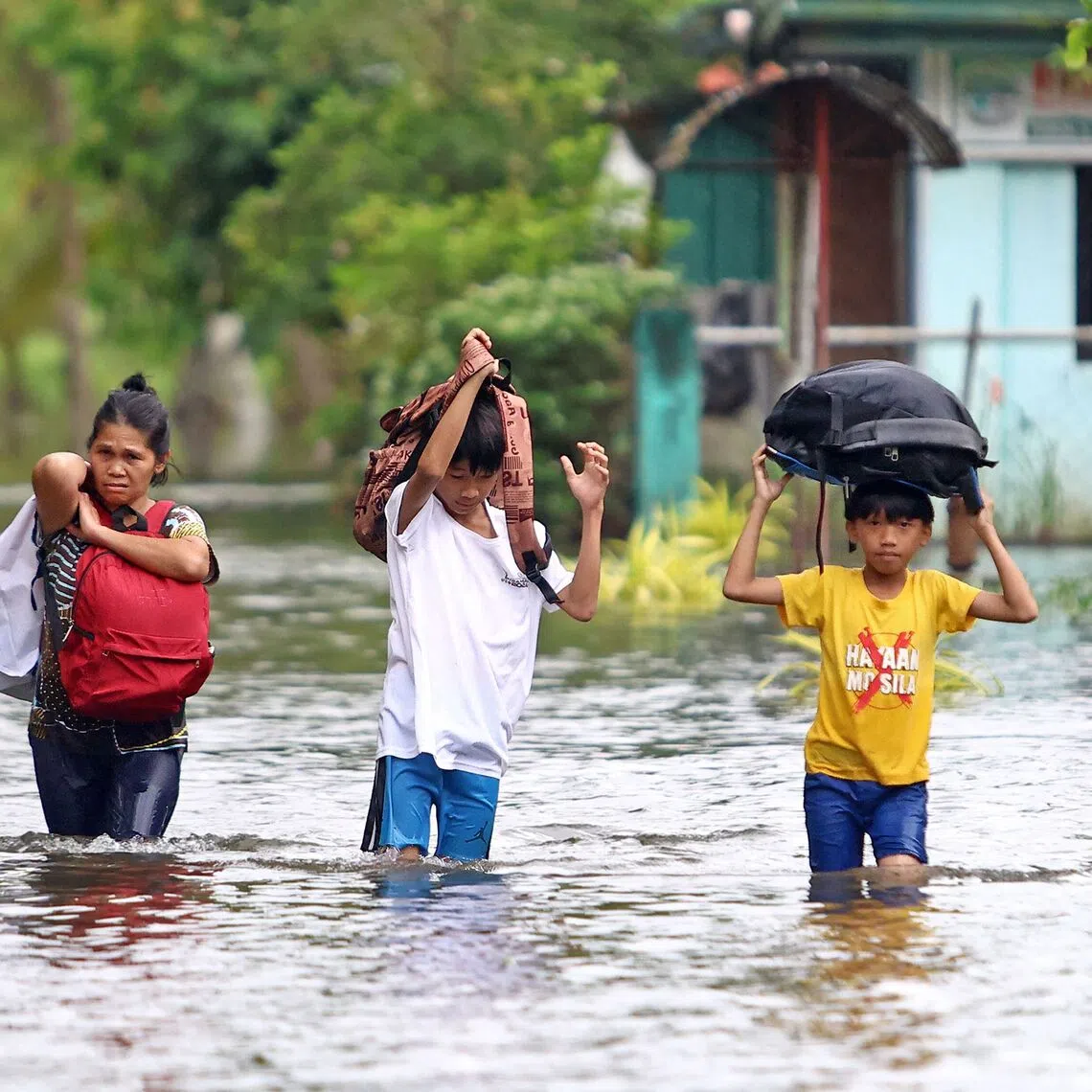Residents evacuate from their flooded homes due to heavy rain brought by Typhoon Fung-wong on the southern island of Mindanao on Nov 8.