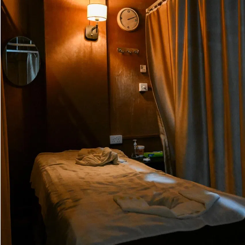 The Straits Times accompanied police officers during the raids on massage parlours in Boon Lay (left) and Jurong West (right).