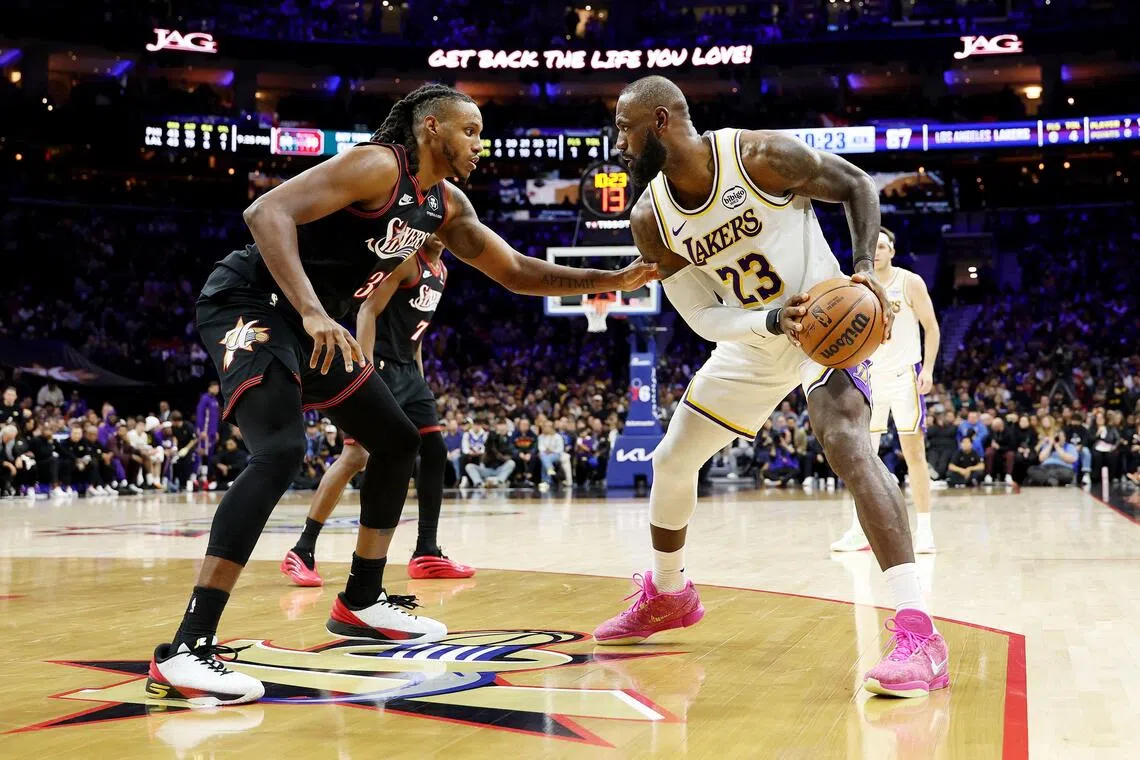 Lebron James of the Los Angeles Lakers drives against Jabari Walker of the Philadelphia 76ers during the second half at Xfinity Mobile Arena.