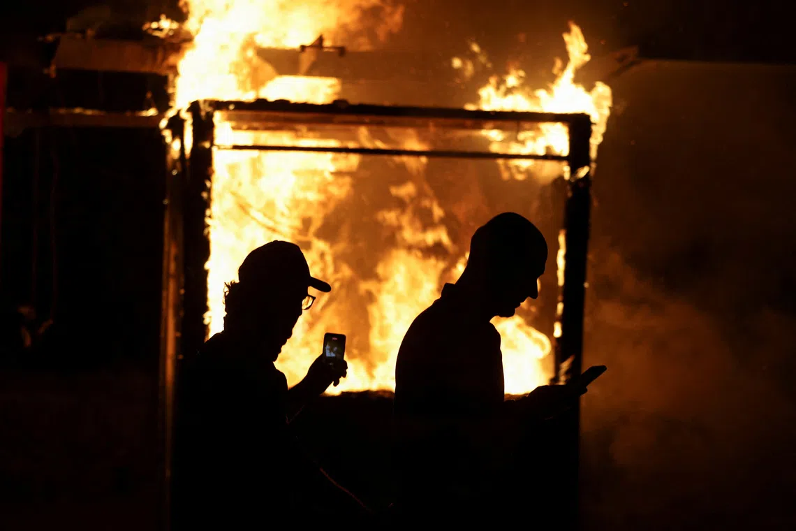A fire during an anti-government protest by students in Tirana, Albania, October 24, 2026. REUTERS/Florion Goga