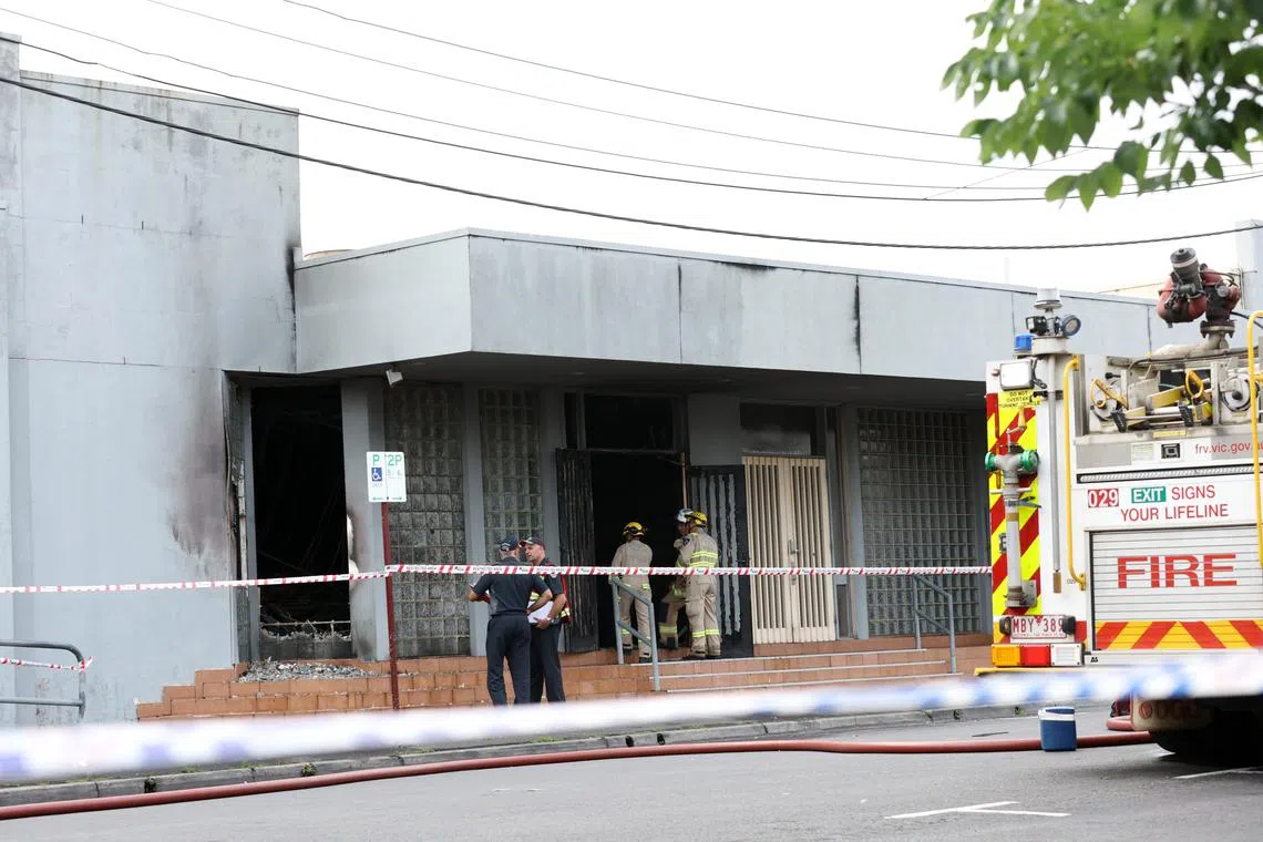 Firefighters work at the scene of a fire at the Adass Israel Synagogue in Ripponlea, Melbourne, on Dec 6.