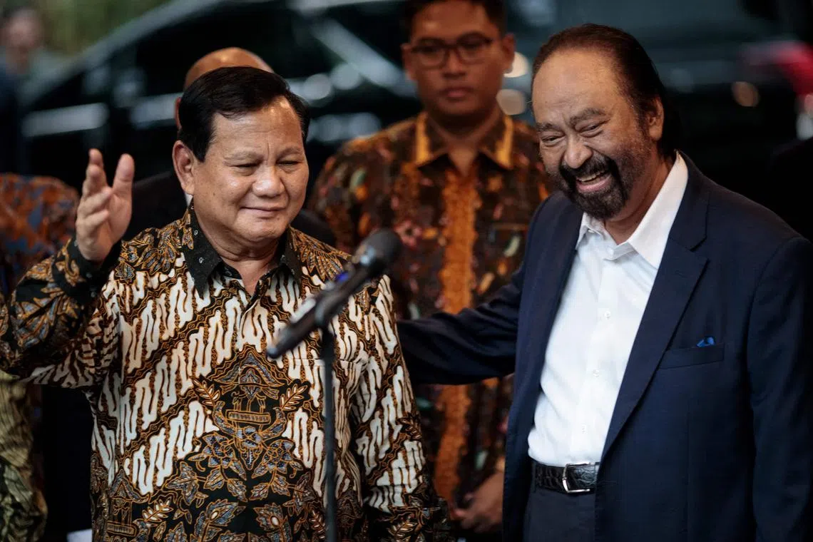 Indonesia's President-elect Prabowo Subianto (left) and Mr Surya Paloh, chairman of the NasDem party and owner of Metro TV, pose for the media after their meeting at Mr Prabowo's home in Jakarta on April 25, 2024.