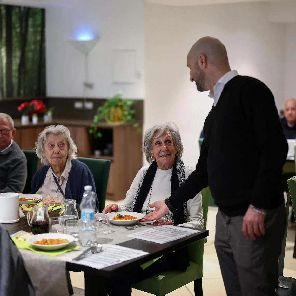 Resident at \"Aris Senior Living\" Giuliana Gorini, 93, is served a dish of pasta during lunch at the facility in Rome, Italy, March 19, 2026. REUTERS/Guglielmo Mangiapane