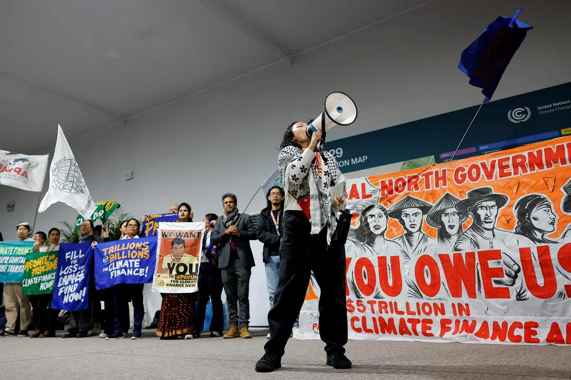 An activist speaks into a megaphone at a protest during the United Nations Climate Change Conference (COP29), in Baku, Azerbaijan November 14, 2024. REUTERS/Maxim Shemetov