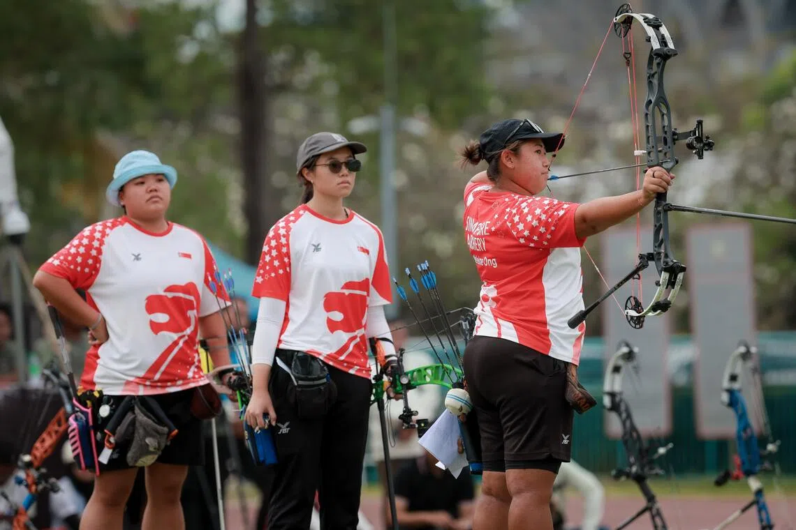 (From right) Singapore's Madeleine Ong wins the SEA Games compound women’s individual gold after teaming up with Jeannice Low and Ellie Low to take silver in the women's team event.