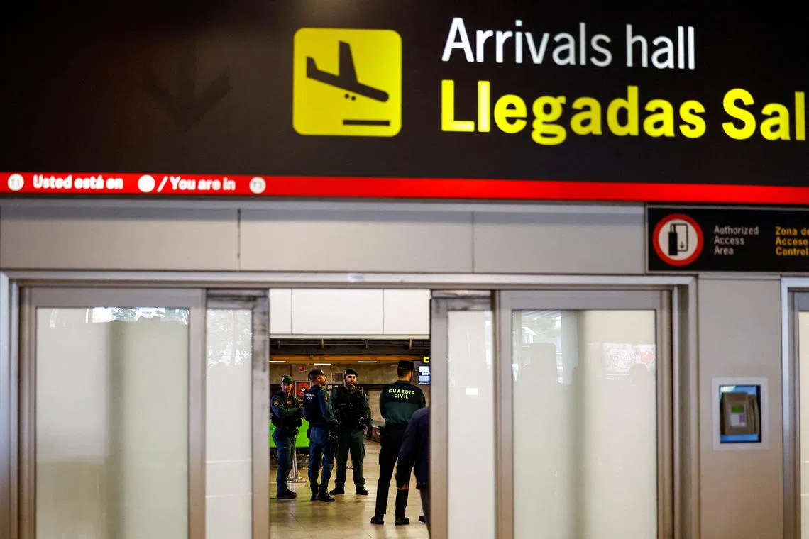 FILE PHOTO: Spanish Civil Guards stand guard at the baggage area of Adolfo Suarez Madrid-Barajas Airport in Madrid, Spain April 3, 2024. REUTERS/Susana Vera/File Photo