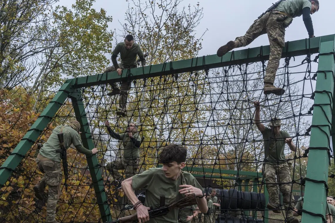 New recruits with the Ukrainian Army’s Third Separate Assault Brigade take part in training in Kyiv on Oct. 22, 2023.