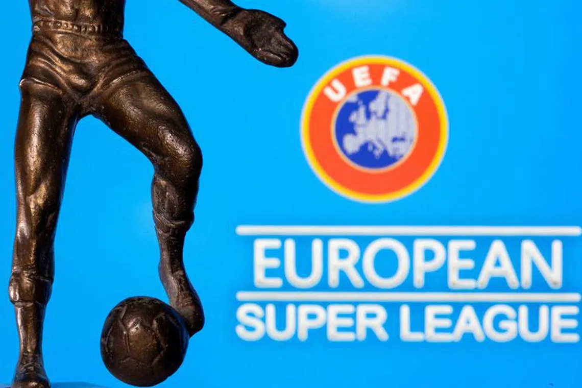 FILE PHOTO: A metal figure of a football player with a ball is seen in front of the words \"European Super League\" and the UEFA logo in this illustration taken April 20, 2021. REUTERS/Dado Ruvic/Illustration/File Photo