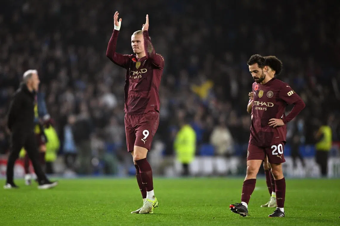 Manchester City's Erling Haaland (left) applauding their fans at full time.